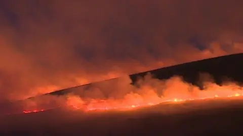 The mountain fire glows red in the dark