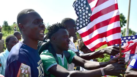 AFP Kenyans with US flags in Kogelo, Kenya - Monday 16 July 2016