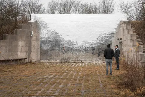 Tomáš Vocelka People standing outside next to a reflective wall