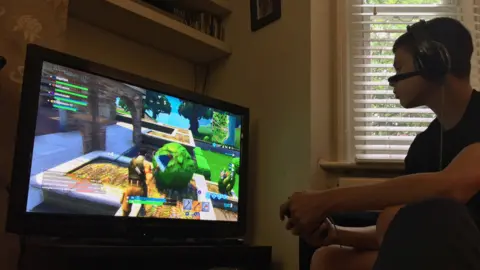 A 14-year-old boy plays Fortnite