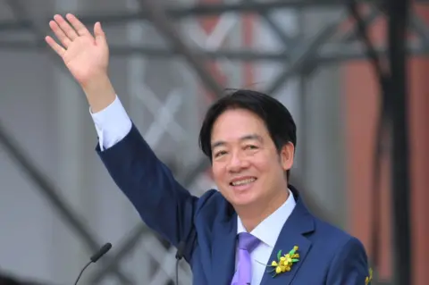 Getty Images Taiwan President Lai Ching-te raises his hand as he delivers his first speech after taking the oath of office during an inauguration ceremony at the Presidential Office Building in Taipei on May 20, 2024. 