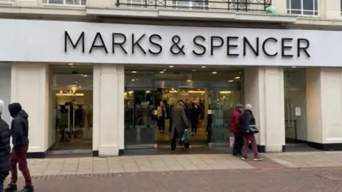 Shannon Eustace/BBC A view of the front of the M&S store in the centre of Ipswich. The white building has the name of the store above the entrance. Shoppers can be seen walking past.