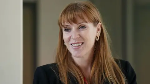 PA Media Angela Rayner talking to members of staff during a visit to London Stansted airport