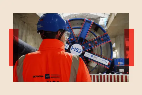 PA Media An HS2 worker stands in front of tunnel at the Old Oak Common station box site