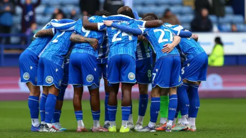 Sheffield Wednesday players in a huddle