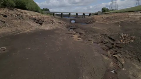 A drone shot of Baitings Reservoir near Ripponden. The bed is entirely exposed and dry.