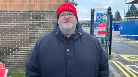 A man with a red NIPsa hat on