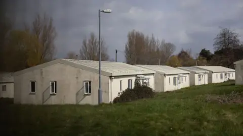 White, low, concrete outbuildings at Northeye