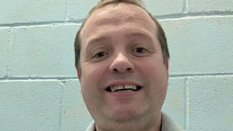 Dave Walton Selfie of a man against a white wall