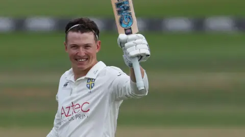 Ben McKinney raises the bat for Durham