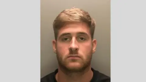 Avon and Somerset Police A mug shot of Jayden Deaken. He has stubble and blonde short hair.