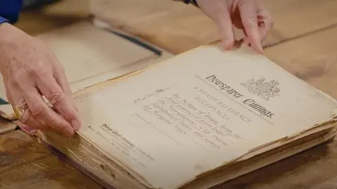 BBC/Ricochet Ltd A close up of the inside of the book before its repair, showing yellowing pages that are rolling at the edges