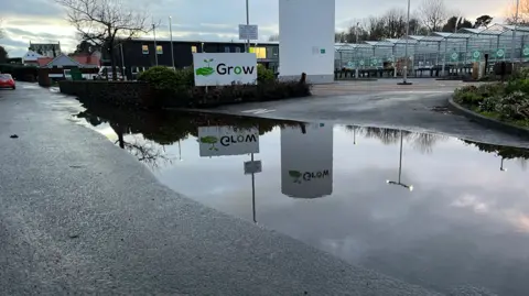 A picture of the flooding. It is a large body of water in front of a number of buildings.