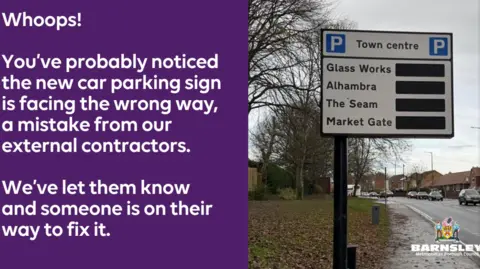 Barnsley Council A split picture - the right-hand side shows a white sign on a road with two blue capital letter P's for parking and a list of car park names underneath.
The left-hand side of the picture says in white lettering on a purple background:
"Whoops! You've probably noticed the new car parking sign is facing the wrong way, a mistake from our external contractors. We've let them know and someone is on their way to fix it."