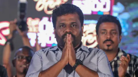 EPA Anura Kumara Dissanayake, presidential candidate and leader of opposition political party National People's Power (NPP), greets supporters during the final campaign rally for the upcoming presidential elections in Nugegoda suburb of Colombo, Sri Lanka, 18 September 2024. 