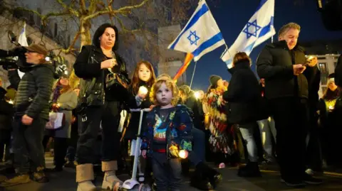 PA Media People during a vigil outside the Australian High Commission in central London, 