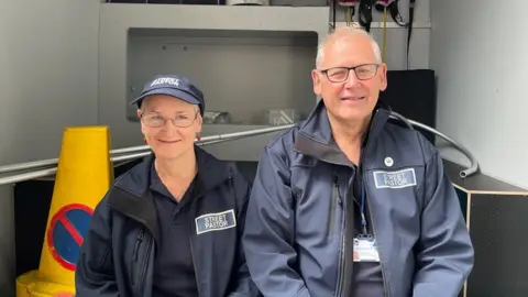 BBC Pastors Jules Taylor and Steve Jones sitting on the back of the van