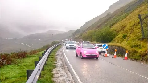 Bear Scotland Cars make their way through traffic lights as the A83 reopened on Monda morning