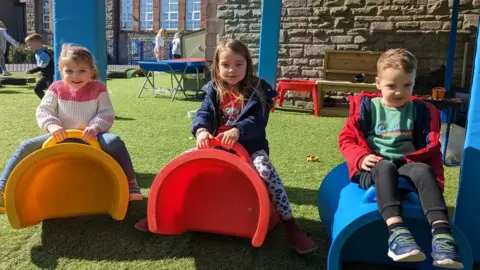 children on outdoor equipment at Menter Iaith Caerffili