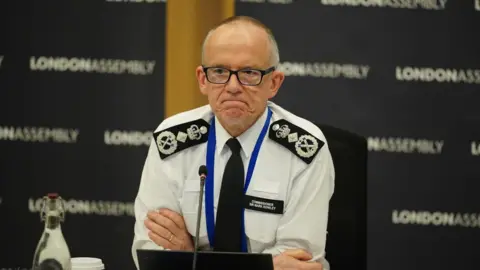 PA Media Image of Sir Mark Rowley with his arms folded at the GLA Police and Crime Committee meeting.