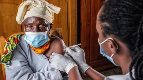 Getty Images Elderly woman receives a Covid vaccine
