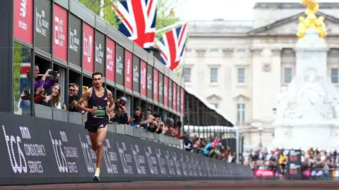 Reuters Britain's Emile Cairess in action before crossing the line to finish third in the men's elite race