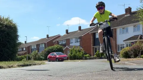 12 year old Dexter on his bike practicing on the streets near his Berkshire home