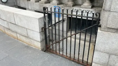 Richard Madden/BBC The locked gates at the door to the public toilet in Hull's Queen Victoria Square