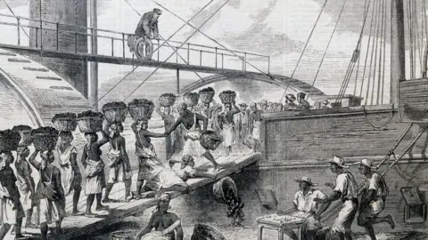 Getty Images Enslaved people loading coal on to a ship