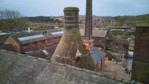 Workers cleaning the bottle oven at Middleport Pottery