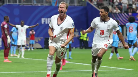 Harry Kane and Jude Bellingham celebrate with DR Congo players in the background