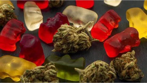 Getty Images Cannabis sweets - known as 'gummies' next to cannabis.