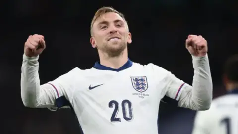 Bowen is in and England kit and has his arms raised during a game.