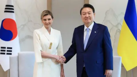 Reuters South Korean President Yoon Suk-yeol shakes hands with Ukraine's first lady Olena Zelenska at the Presidential Office in Seoul, South Korea, May 16, 2023.