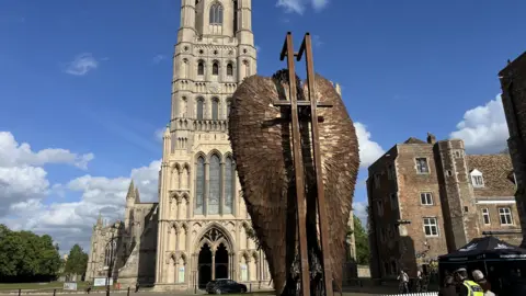 John Devine/BBC back of the Knife Angel with the cathedral in the background. it is a bright sunny evening in Ely
