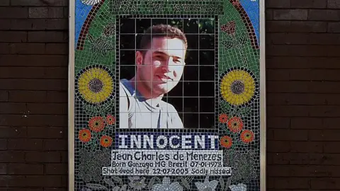 Getty Images A mosaic memorial to Jean Charles de Menezes outside Stockwell Underground station in London. It reads "Innocent. Jean Charles de Menezes. Born Gonzaga MG Brazil 07-01-1978. Shot dead here 22-07-2005. Sadly missed."