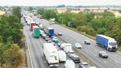 Lots of queuing traffic on the M1, showing several lanes of traffic. There are other vehicles on the other side of the road. 