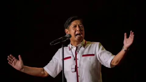 Getty Images Ferdinand "Bongbong" Marcos Jr. speaks to supporters during his last campaign rally before the election