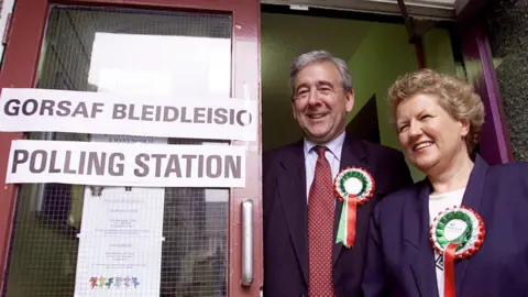 PA Media Dafydd Wigley and his wife Elinor at a polling station for the 1999 Assembly election