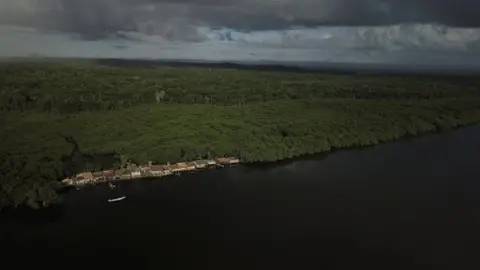 Nacho Doce / Reuters Aerial shot of a collection of houses by the Caratingui river in Brazil