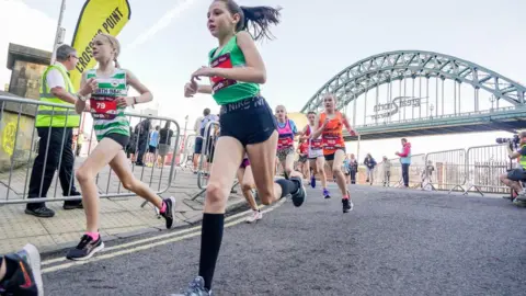 NNP Young runners cross the Swing Bridge as part of the Mini and Junior Great North Runs