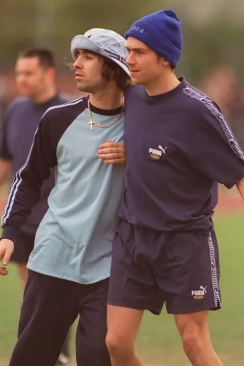 Getty Images Liam Gallagher jostling Damon Albarn during a music industry celebrity football match