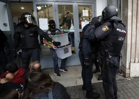 Getty Images Police seize ballot boxes from a polling station