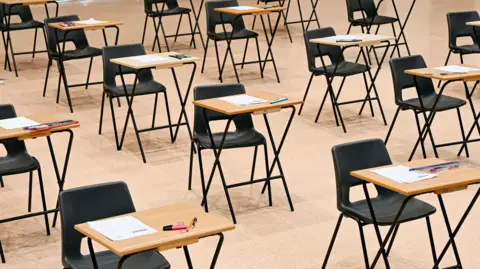 A school hall with desks arranged for exams