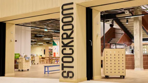 Stockroom has a wooden entrance with Stockroom written in black letters