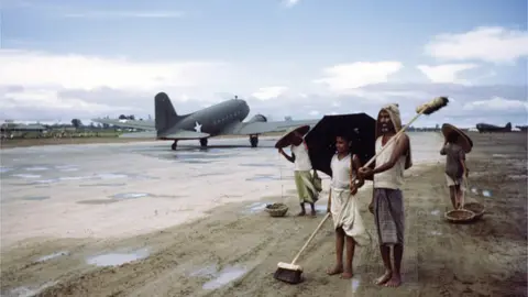 Getty Images A view local Indians sweeping the military runway in fields in Sadiya, Assam India. Circa 1943. (Photo by Ivan Dmitri/Michael Ochs Archives/Getty Images)