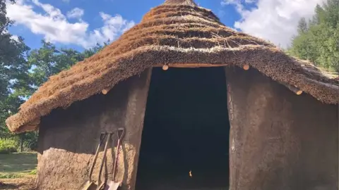 Flag Fen A roundhouse replica with a thatched roof