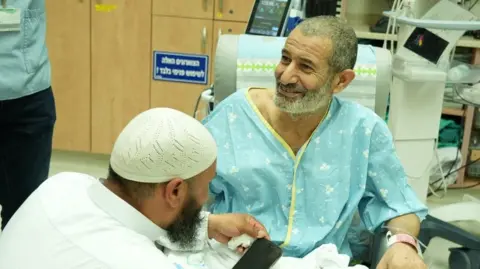 Reuters This photo provided by the Israeli government shows rescued Bedouin hostage Kaid Farhan Elkadi talking to relatives at Soroka Medical Center in Beersheba, Israel (August 27, 2024)