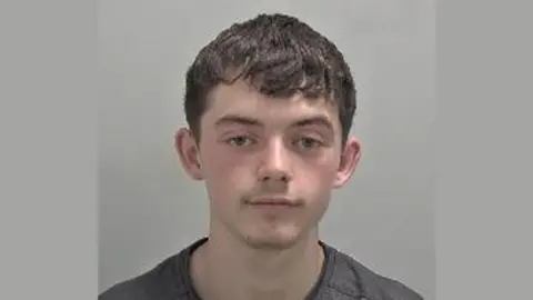 A mugshot of Michael Leese, 18, with a grey background