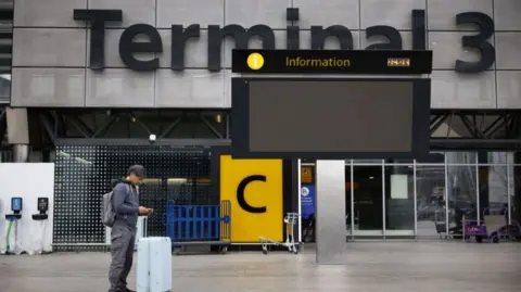 A person standing at Heathrow terminal 